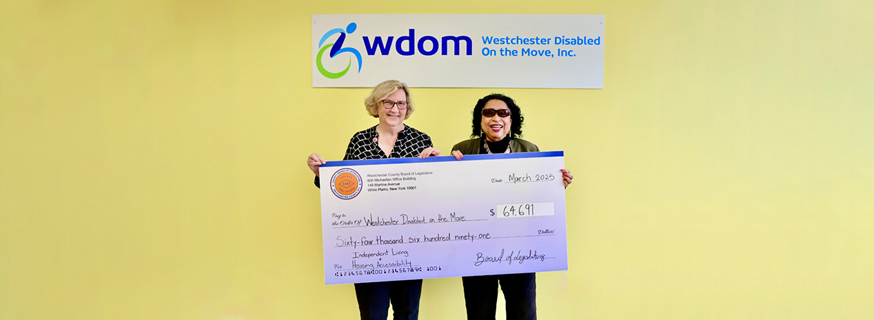 Legislator Nancy E. Barr presents check to Maria Samuels, Executive Director of WDOM